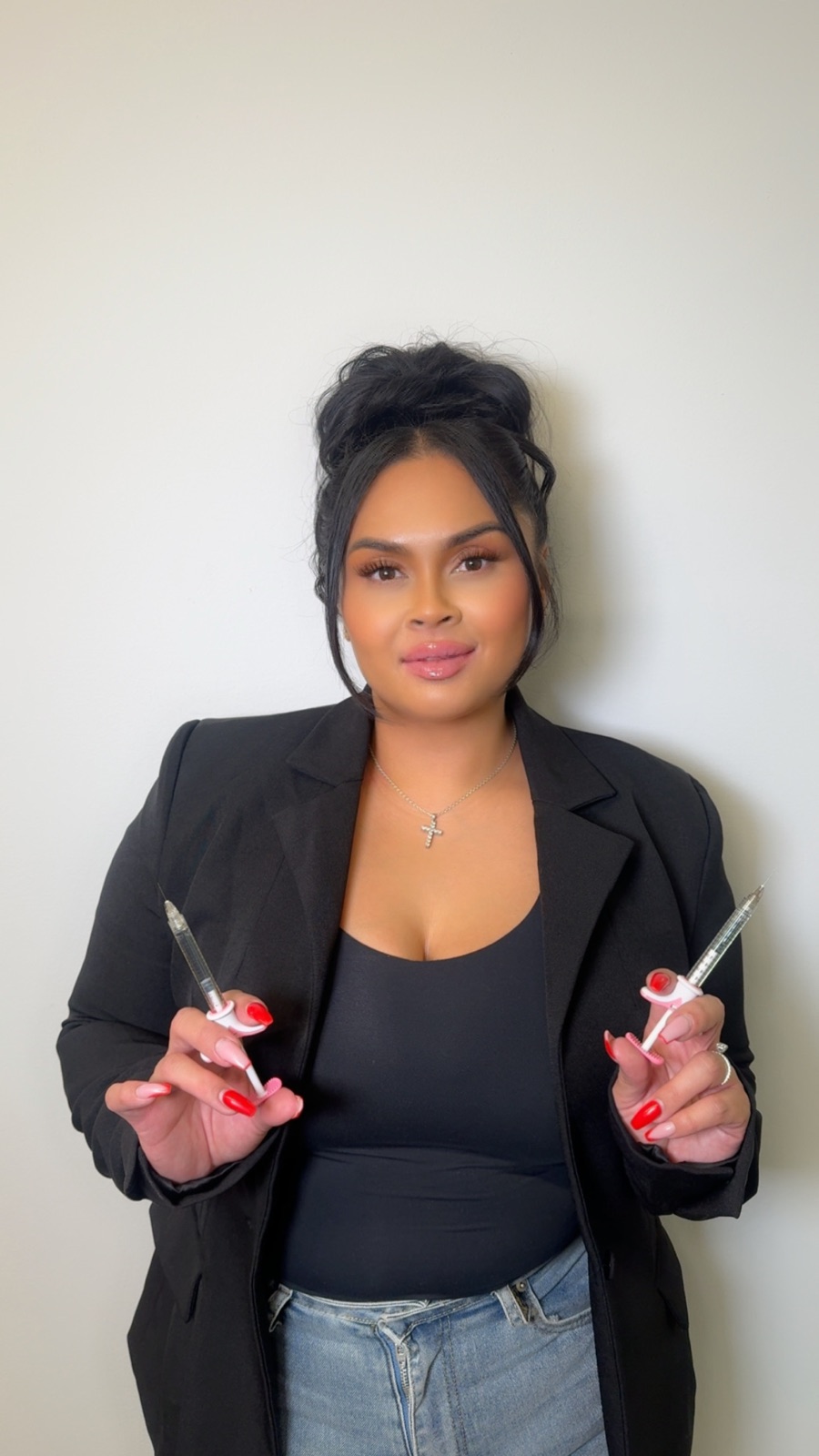 April Cortez, founder of NAR Med Bar, holding injectables